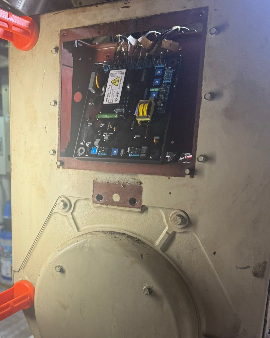 Voltage regulator board inside an open generator housing