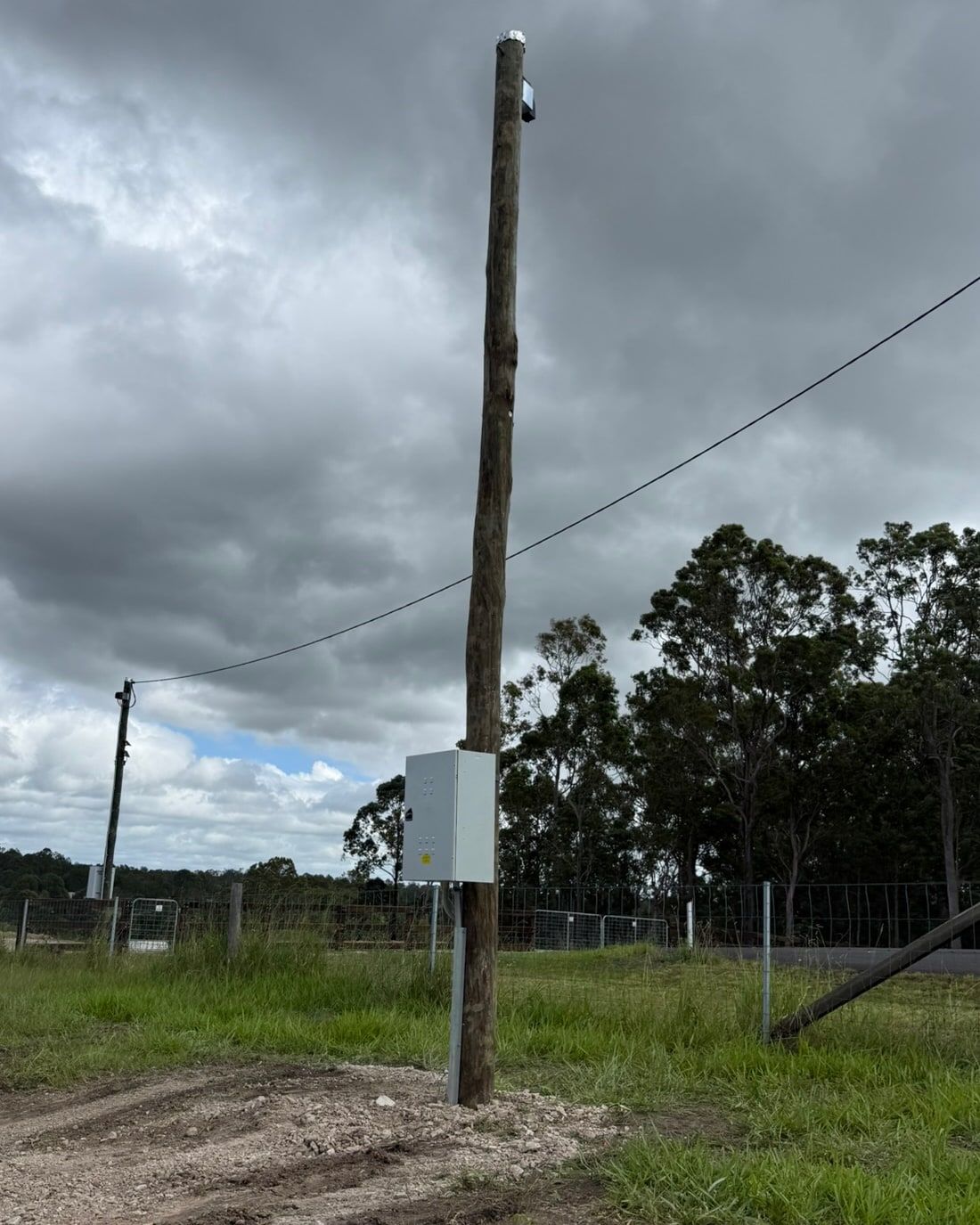 New power pole with a switchboard enclosure on a rural property
